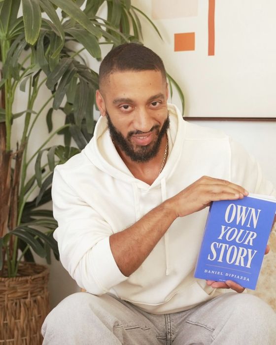 Daniel DiPiazza holding Own Your Story